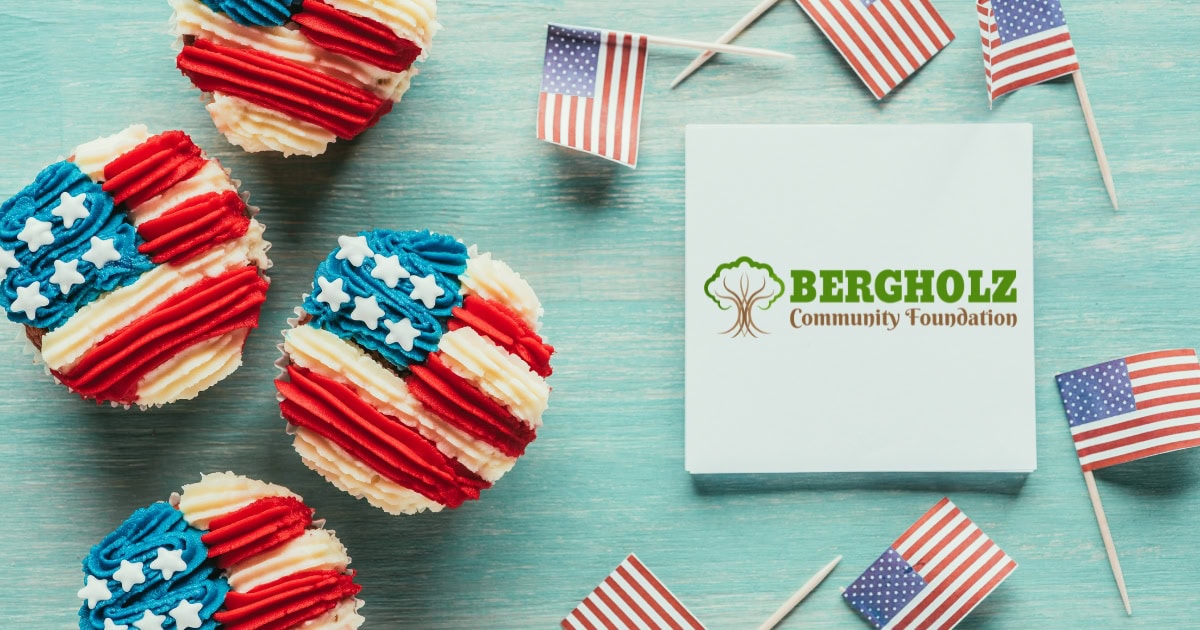 Mini USA flags, cupcakes decorate with a USA flag and the Bergholz Community Foundation