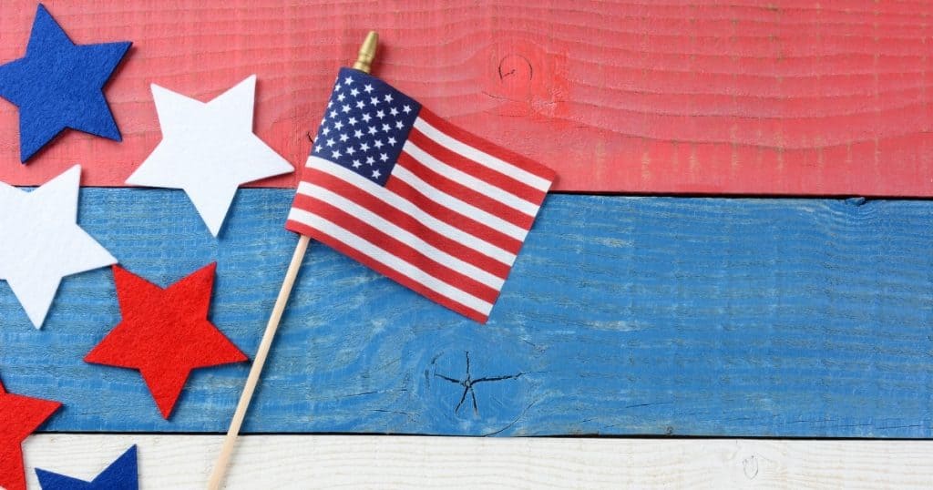 US flag, red, white and blue stars on wood background