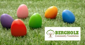 Colorful dyed Easter eggs in grass with the Bergholz Community Foundation logo.